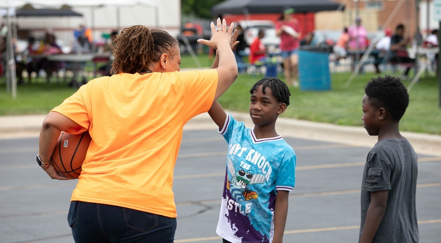 School adminitrator high fiving students
